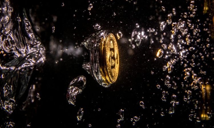 Una moneta dei Bitcoin con bolle d'acqua