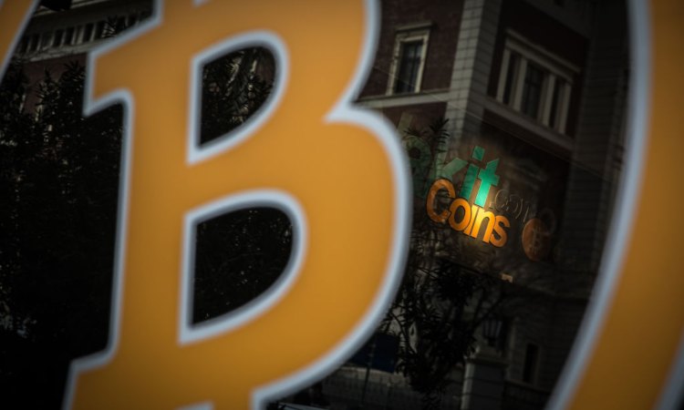 Il simbolo giallo di BTC con la scritta coins sullo sfondo