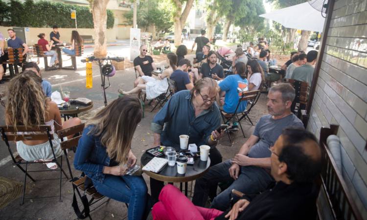 I tavoli esterni di un bar pieni di gente