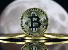 Un po' di monete in Bitcoin con sullo sfondo la luna